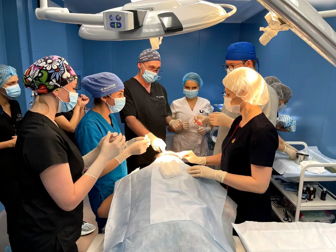 Trainee doctors assisting Dr. Tsilosani during a private-patient hair transplant procedure