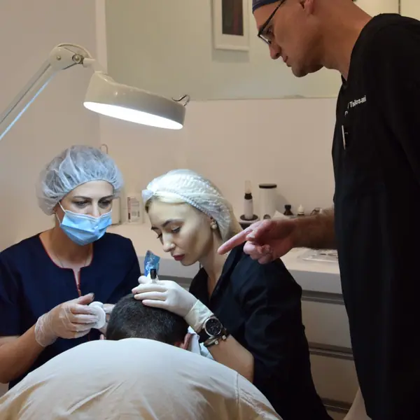 Trainees preparing a patient under Dr. Tsilosani's supervision